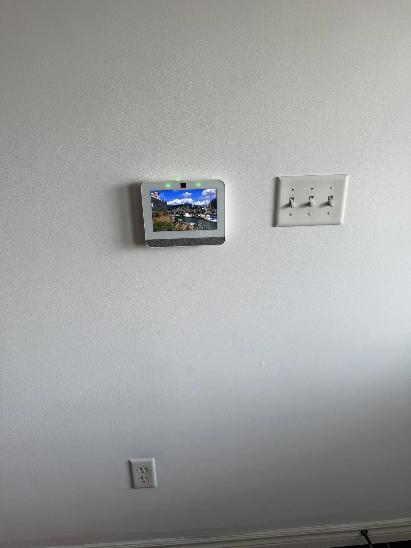 Qolsys IQ alarm panel mounted on a hallway wall