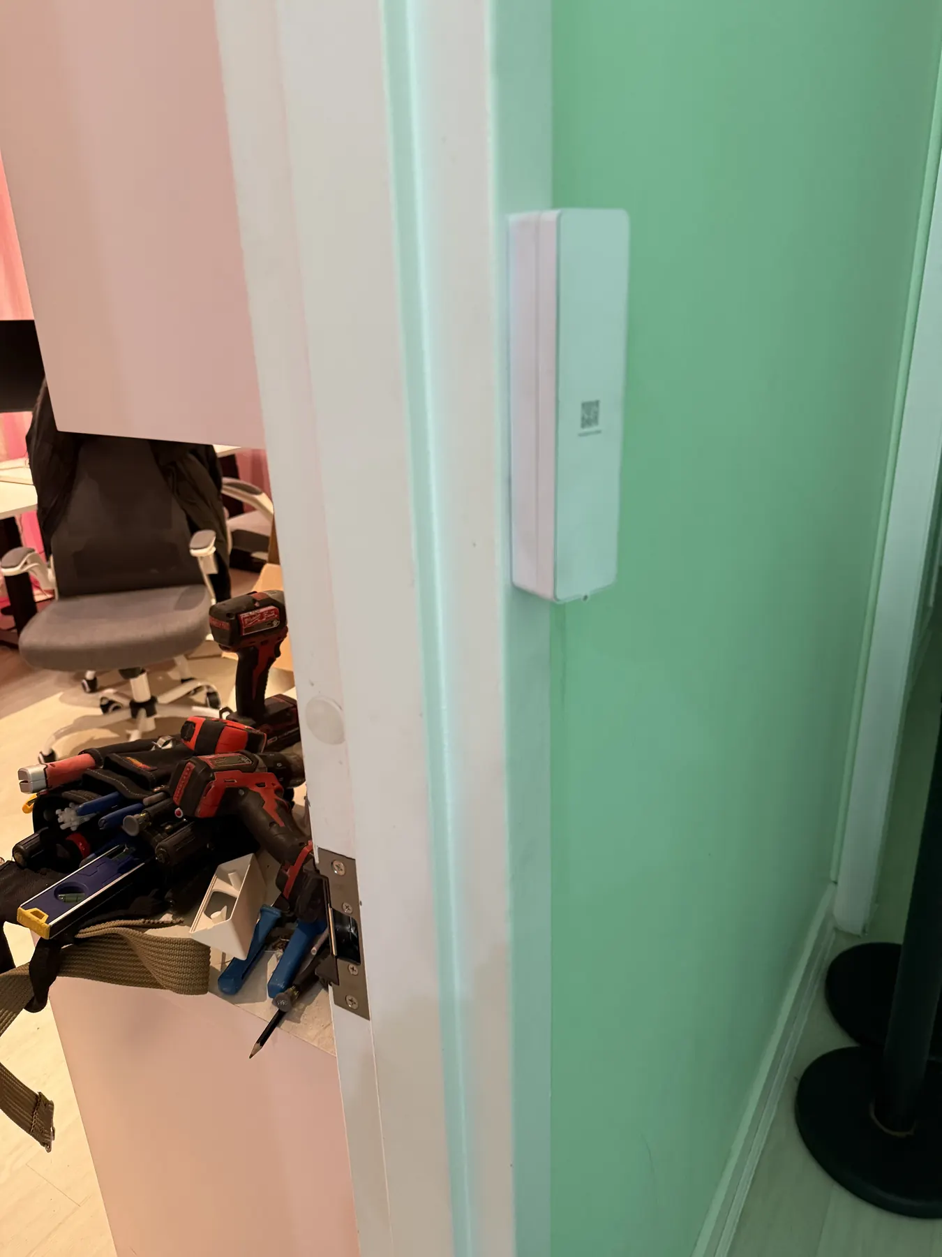 Door contact fitted to an office door frame during a card access install
